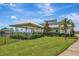 Exterior view of the community clubhouse, featuring a covered area, garden, and well-maintained landscaping at 18164 Turning Leaf Cir, Land O Lakes, FL 34638
