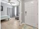 Inviting entryway with hardwood floors, leading to a bedroom with a decorative rug and a gray color scheme at 18164 Turning Leaf Cir, Land O Lakes, FL 34638