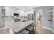 Modern kitchen featuring white cabinets, stainless steel appliances, and a spacious granite countertop island at 18164 Turning Leaf Cir, Land O Lakes, FL 34638