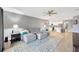 Spacious living room that flows into a modern kitchen, featuring a comfortable sofa and large rug at 18164 Turning Leaf Cir, Land O Lakes, FL 34638