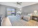 Open-concept living room featuring a comfortable sofa, large area rug, and sliding glass doors to the patio at 18164 Turning Leaf Cir, Land O Lakes, FL 34638