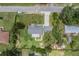 Bird's eye view of a gray roofed home with a long drive in a neighborhood with mature trees at 2612 Lenna Ave, Seffner, FL 33584