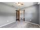 This bedroom features neutral carpeting, grey paint, a ceiling fan, and a closet with white shelving at 2612 Lenna Ave, Seffner, FL 33584