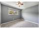 Empty bedroom with neutral walls, carpeting, and natural light from the window at 2612 Lenna Ave, Seffner, FL 33584