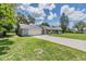 The exterior of this inviting home features an attached garage, a long driveway, and a green lawn at 2612 Lenna Ave, Seffner, FL 33584
