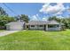 Charming single-story home with well-maintained lawn, attached garage and inviting front porch at 2612 Lenna Ave, Seffner, FL 33584