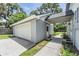 This image features an attached, single-car garage with extra side parking and a walkway to the front door at 2612 Lenna Ave, Seffner, FL 33584
