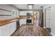 Updated kitchen features white cabinets, stainless steel appliances, and gorgeous wood countertops at 2612 Lenna Ave, Seffner, FL 33584