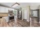 Modern kitchen with stainless steel appliances, wood countertops, and white cabinets at 2612 Lenna Ave, Seffner, FL 33584