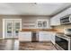 Charming kitchen featuring butcher block countertops, stainless steel appliances, and white cabinetry at 2612 Lenna Ave, Seffner, FL 33584