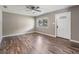 Bright living room showcasing stylish flooring, a ceiling fan, and a large window for natural light at 2612 Lenna Ave, Seffner, FL 33584