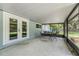 Covered and screened patio space with a table and chairs for outdoor dining and entertaining at 2612 Lenna Ave, Seffner, FL 33584