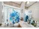 Well-lit bathroom features a shower-tub combination and decorative elements at 371 Quane Ave, Spring Hill, FL 34609