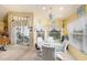 Bright breakfast nook features a glass table, seating for four, and access to the lanai at 371 Quane Ave, Spring Hill, FL 34609
