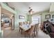 Elegant dining room with a ceiling fan, a view of the backyard, and stylish decor at 371 Quane Ave, Spring Hill, FL 34609