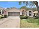 Charming single-story home with a well-manicured lawn, screened garage, and lovely curb appeal at 371 Quane Ave, Spring Hill, FL 34609