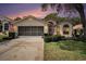 Charming single-story home with a well-manicured lawn, screened garage, and lovely curb appeal at 371 Quane Ave, Spring Hill, FL 34609