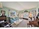Bright living room with large windows, comfortable seating, and a cozy atmosphere at 371 Quane Ave, Spring Hill, FL 34609