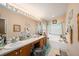 Bright main bathroom with dual sinks, a soaking tub, and a vanity area with ample counter space at 371 Quane Ave, Spring Hill, FL 34609