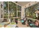 Cozy screened porch featuring comfortable seating and views of the lush backyard at 371 Quane Ave, Spring Hill, FL 34609