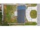 An aerial view displays a property with modern landscaping and a well-maintained backyard at 3909 W Oklahoma Ave, Tampa, FL 33616