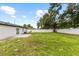 Spacious backyard featuring a concrete patio, a lush green lawn, and a privacy fence at 3909 W Oklahoma Ave, Tampa, FL 33616