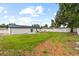 This backyard has a sprawling lawn and a privacy fence at 3909 W Oklahoma Ave, Tampa, FL 33616