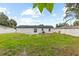 A spacious backyard features a grassy lawn and a white fence at 3909 W Oklahoma Ave, Tampa, FL 33616