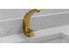 Close up on bathroom showing brushed gold faucet and quartz countertops at 3909 W Oklahoma Ave, Tampa, FL 33616