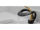 Unique black and gold bathroom faucet with a modern, sculptural design at 3909 W Oklahoma Ave, Tampa, FL 33616