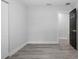 Neutral bedroom with light wood floors and a black door at 3909 W Oklahoma Ave, Tampa, FL 33616