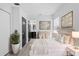 This staged bedroom has warm neutral tones and a glimpse into the primary ensuite at 3909 W Oklahoma Ave, Tampa, FL 33616