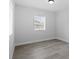 A bright bedroom features neutral walls, baseboard and a window at 3909 W Oklahoma Ave, Tampa, FL 33616