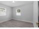 Bright bedroom with two windows and a door and wood-look flooring at 3909 W Oklahoma Ave, Tampa, FL 33616