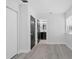A bright bedroom features a closet, neutral walls, and wood-look flooring at 3909 W Oklahoma Ave, Tampa, FL 33616