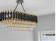 Elegant chandelier with black and gold accents and tiered crystal pendants adds a touch of luxury at 3909 W Oklahoma Ave, Tampa, FL 33616