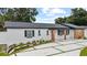 Attractive single-story home with a modern driveway design and neat, new landscaping at 3909 W Oklahoma Ave, Tampa, FL 33616