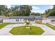 Charming single-story home with a well-manicured lawn and modern driveway at 3909 W Oklahoma Ave, Tampa, FL 33616