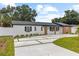 Lovely single-story house featuring new landscaping and a unique concrete driveway design at 3909 W Oklahoma Ave, Tampa, FL 33616