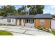 Inviting single-story home with modern driveway and fresh landscaping enhancing curb appeal at 3909 W Oklahoma Ave, Tampa, FL 33616