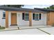 Inviting front porch with natural wood accents and stylish landscaping at 3909 W Oklahoma Ave, Tampa, FL 33616
