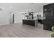 Spacious kitchen boasts an island, modern appliances, black and white cabinets, and stylish lighting at 3909 W Oklahoma Ave, Tampa, FL 33616