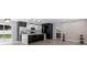 Modern kitchen boasts sleek black and white cabinets, island, and stainless steel appliances at 3909 W Oklahoma Ave, Tampa, FL 33616