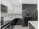 Modern kitchen includes new appliances, island, modern black and gold hardware, and lots of counter space at 3909 W Oklahoma Ave, Tampa, FL 33616