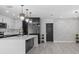 Stylish kitchen with modern cabinets, quartz island, and decorative lighting; perfect for cooking and entertaining at 3909 W Oklahoma Ave, Tampa, FL 33616
