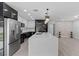 Bright kitchen features a spacious island, stainless steel appliances and modern lighting fixtures at 3909 W Oklahoma Ave, Tampa, FL 33616