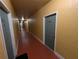 Hallway with multiple apartment doors, lit by overhead lighting, and painted in neutral colors at 4207 S Dale Mabry Hwy # 6212, Tampa, FL 33611