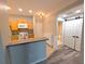 Kitchen featuring a stainless steel sink, white appliances, and an adjacent bathroom with sliding barn doors at 4207 S Dale Mabry Hwy # 6212, Tampa, FL 33611