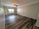 Living room featuring hard surface floors, a ceiling fan, neutral paint, and a large window at 4207 S Dale Mabry Hwy # 6212, Tampa, FL 33611