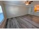 Bright living room featuring hard surface floors, a ceiling fan, neutral paint, and an open view to the kitchen at 4207 S Dale Mabry Hwy # 6212, Tampa, FL 33611